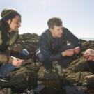 Mentor and mentees crouching at Bodega Marine Lab